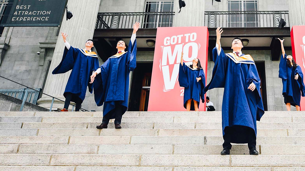 Graduates are flying their caps in the air