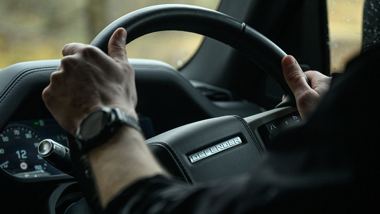 Closeup of man hand on steering wheel