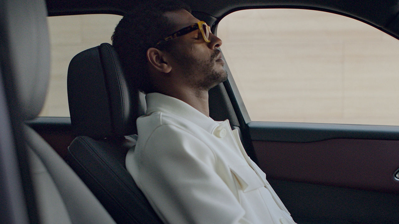 A man relaxing in the passenger seat of Range Rover