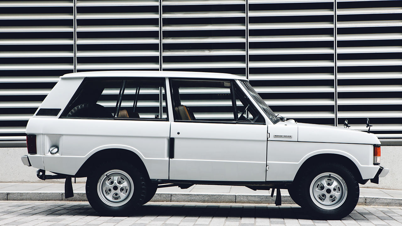 White Range Rover old model parked
