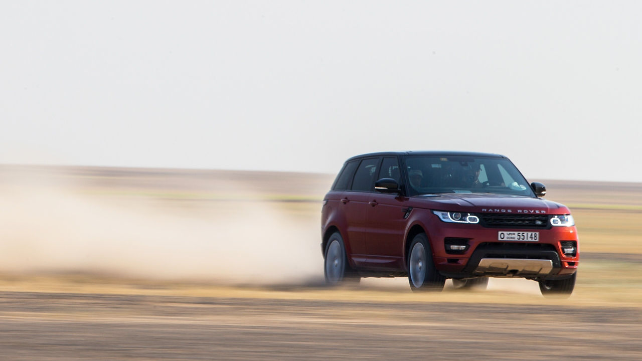 Range Rover Sports driving on sand road