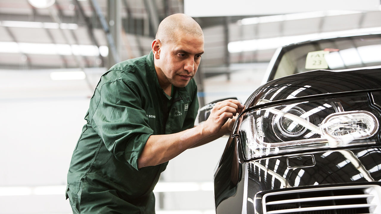 Range Rover car detailing and hands of professional car service male worker