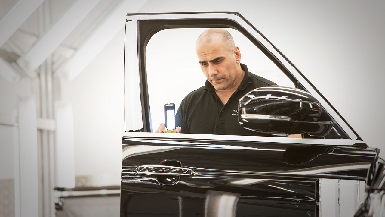 Range Rover car door detailing and hands of professional car service male worker