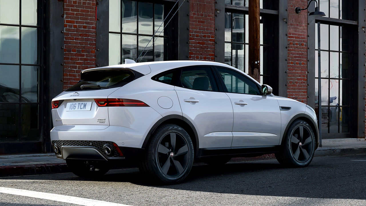Parked Jaguar E-Pace be side bricks wall building 