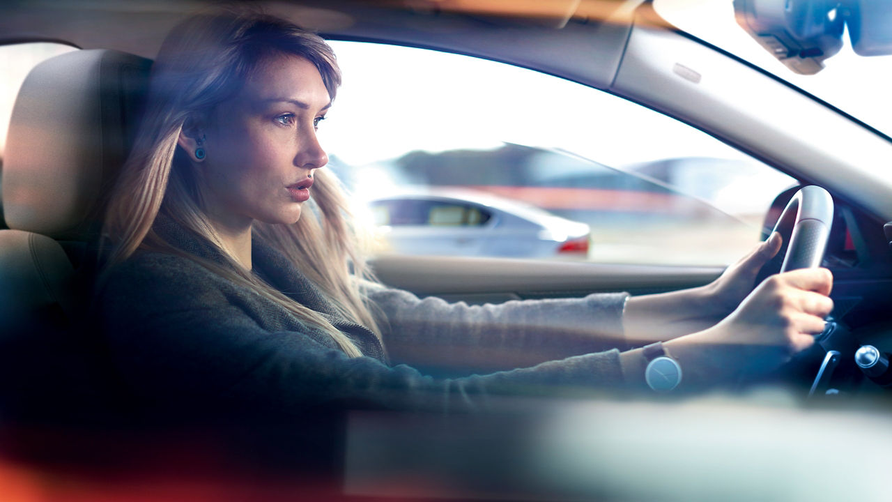 Woman is driving modern luxury car