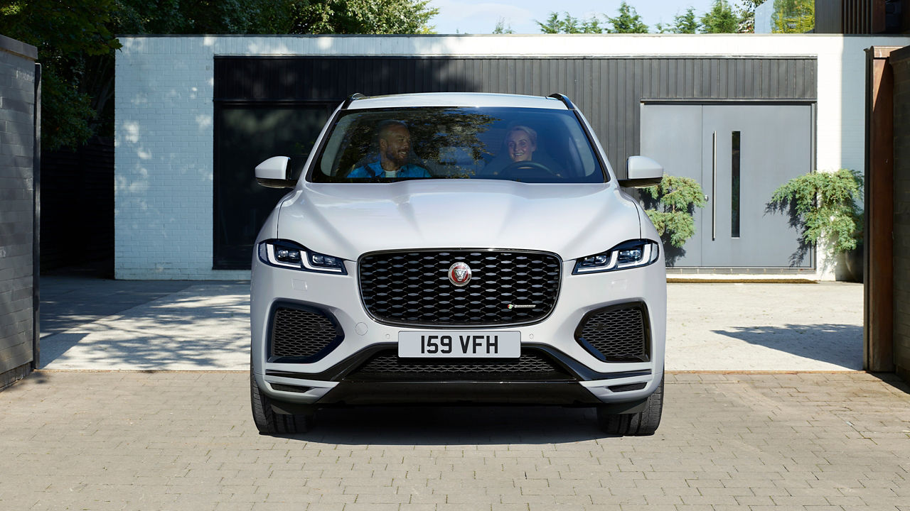 Couple enjoying ride in Jaguar F-Pace 