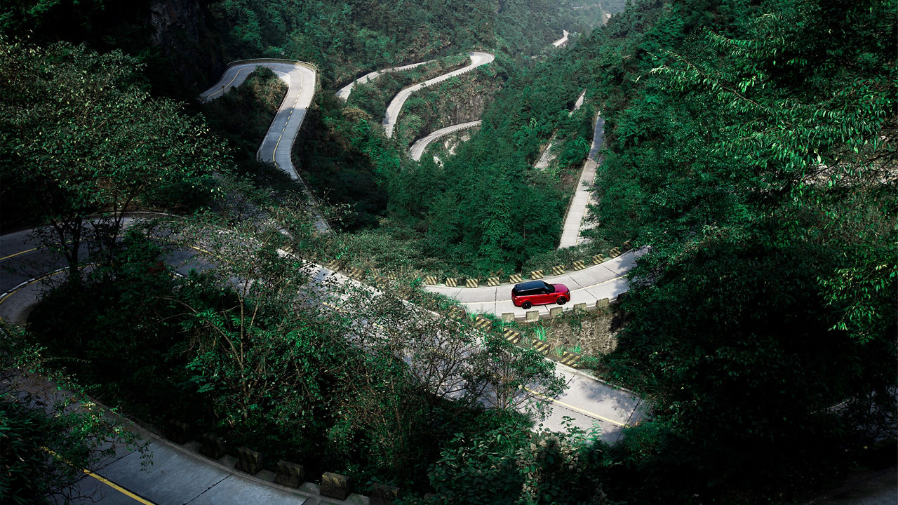 Range Rover Sports on path through mountains