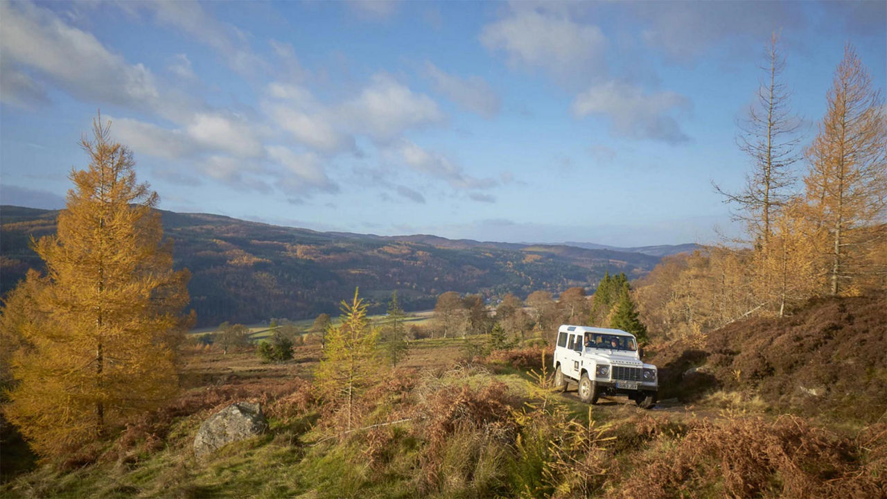 Land Rover Vehicle driving through Scotland Landscape 